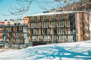 a large building with snow in front of it at Didveli Gallery B-110 in Bakuriani