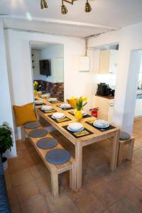 a dining room table with chairs and a long table at Spacious Apartment in urban location in Hamburg