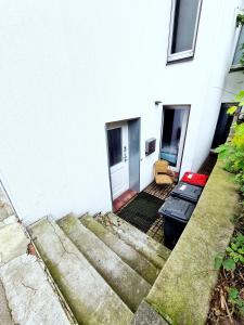 a white house with stairs leading up to it at Spacious Apartment in urban location in Hamburg