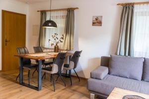uma sala de estar com uma mesa e um sofá em Appartements Gadenstätter em Maria Alm am Steinernen Meer