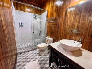 a bathroom with a shower and a toilet and a sink at Villa Phathana Royal View Hotel in Luang Prabang