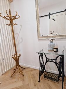 a glass table and a mirror in a room at Apartmán Singer in Banská Štiavnica +6 photos