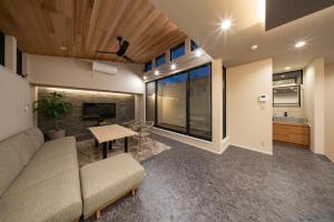 a living room with a couch and a table at Besso姫路 in Himeji