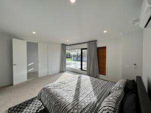 a bedroom with a large bed and a large window at Sun and Sea Holiday Home in Cowes