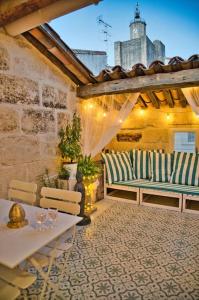 a patio with two chairs and a table and a table and bench at Appartement-Terrasse Centre Historique in Uzès