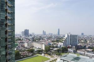 a view of a city from a tall building at Chatrium Hotel Riverside Bangkok in Bangkok