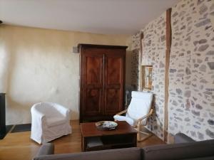 a living room with a couch and a chair at Le Relais d'Anglards in Anglards-de-Saint-Flour