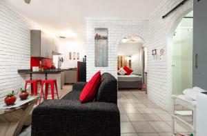 a living room with a couch and a kitchen at Rozelee Rest 1 in Nelspruit