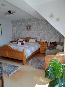 ein Schlafzimmer mit einem Bett und einem Sofa in der Unterkunft Fewo ,Sonnenstübchen, in Mendig