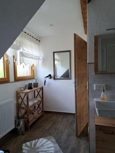 ein Bad mit einem Waschbecken und einem Spiegel in der Unterkunft Fewo ,Sonnenstübchen, in Mendig