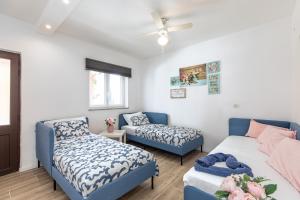 a living room with a bed and a couch at Apartment Dida i Mara in Malinska +51 photos