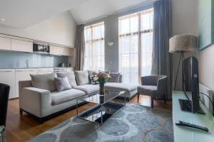 a living room with a couch and a table at Artillery Lane in London