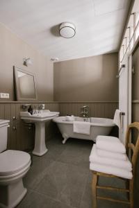 a bathroom with a tub and a toilet and a sink at La Maison d’Hôtes in Silly