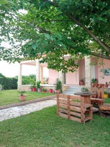 a picnic table and bench in front of a house at Villa Erasmia in Dhékarkhon