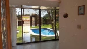 a view of a pool through a sliding glass door at Casa con Alberca en Atlixco Puebla in Atlixco