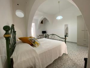 a bedroom with a bed in a white room at Case Gandolfo in Favignana