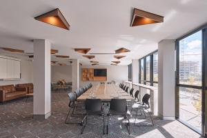 a conference room with a long table and chairs at Rydges Perth Kings Square in Perth