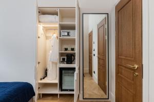 a mirror in a closet with a door and a room at On The Square in Lviv
