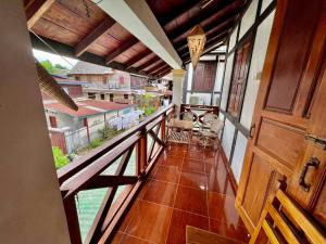 an empty balcony with a view of a house at Nocknoy Lanexang Guest House in Luang Prabang