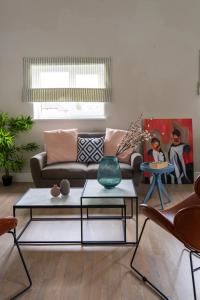 a living room with a couch and two tables at Beautiful New 2 Bed Flat - 5 August House in London