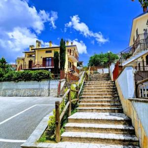 a set of stairs next to a street with houses at La Libellula apartment (Il tuo Chalet sul colle) in Castel di Sangro