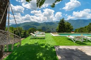 a view of a yard with chairs and a swimming pool at Villa Rose in Zagvozd, Makarska hinterland in Zagvozd