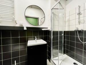 a bathroom with a sink and a mirror at Chillout Dorm Cracow by BookingHost in Krakow