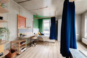 an office with a blue curtain in a room at Chillout Dorm Cracow by BookingHost in Krakow