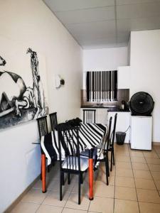 a kitchen with a table and chairs in a room at Leather and Lace & a Suitcase in Groutfontein