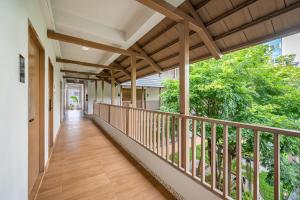 a balcony of a home with a wooden walkway at Hotel Wizpark Ratchada in Bangkok