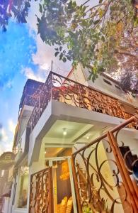 a building with a staircase and a balcony at NomadsMNL Hostel in Manila