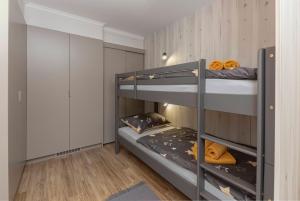 a bunk bed room with two bunk beds at Apartments Ribnica in Bohinj