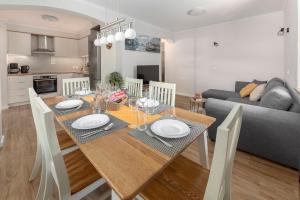 a dining room and kitchen with a table and chairs at Apartments Ribnica in Bohinj