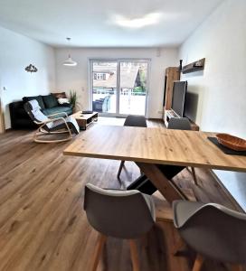 a living room with a wooden table and chairs at Ferienwohnungen Alpenliebe & Auszeit in Sonthofen