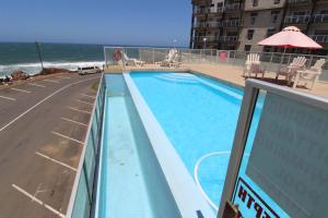 een balkon met uitzicht op een zwembad en de oceaan bij Seagull 513 in Margate