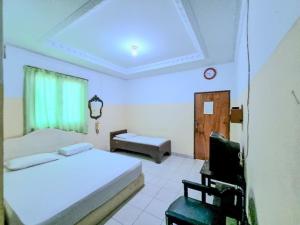 Postel nebo postele na pokoji v ubytování Hotel Taman Sari