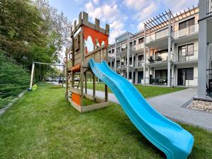 a playground with a blue slide in front of a building at Premium Apartment by Hi5 - Zamardi One-bedroom in Zamárdi
