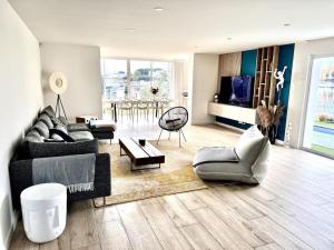 a living room with a couch and a table at VILLA D'EXCEPTION - MARINA PISCINE ROOFTOP 10 PERSONNES - 4 Etoiles in Cap d'Agde