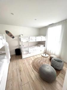a bedroom with two bunk beds and a wooden floor at VILLA D'EXCEPTION - MARINA PISCINE ROOFTOP 10 PERSONNES - 4 Etoiles in Cap d'Agde +19 photos