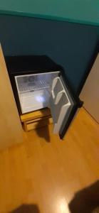 a small refrigerator with its door open in a room at CHARLOTTE, not for parties, not a hotel, room with shared bathroom, no kitchen in Amsterdam +32 photos