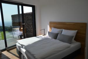 a bedroom with a bed and a large window at Bergweide 36 in Sasbachwalden