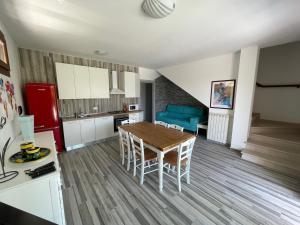 a kitchen and living room with a table and chairs at VILLA SALICE 9.2 in Isola Albarella