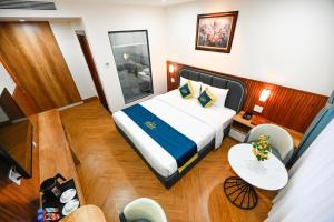 Postel nebo postele na pokoji v ubytování PLUS VUNG TAU HOTEL