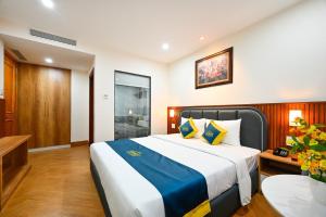 Postel nebo postele na pokoji v ubytování PLUS VUNG TAU HOTEL