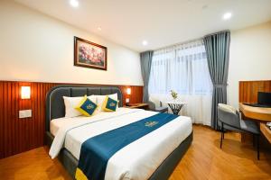 Postel nebo postele na pokoji v ubytování PLUS VUNG TAU HOTEL