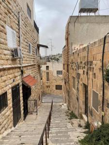 an alleyway in an old brick building with a staircase at Traditional Palestinian Home in Beit Sahour
