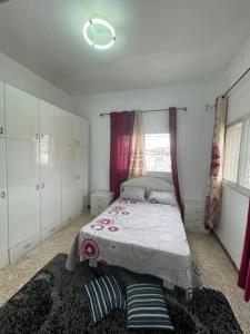 a bedroom with a bed and a window and a rug at Traditional Palestinian Home in Beit Sahour