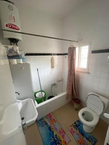 a small bathroom with a toilet and a sink at Traditional Palestinian Home in Beit Sahour