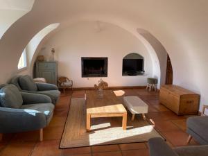 a living room with a couch and a coffee table at La Sauveterre in Mours-Saint-EusÃ¨be