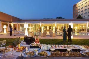 a buffet of food on a table in front of a building at The Sydney Hotel in Bologna